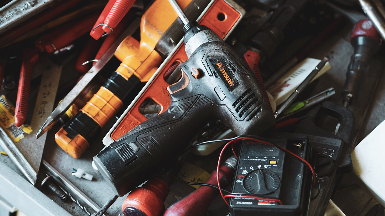 A toolbox full of various hand and power tools