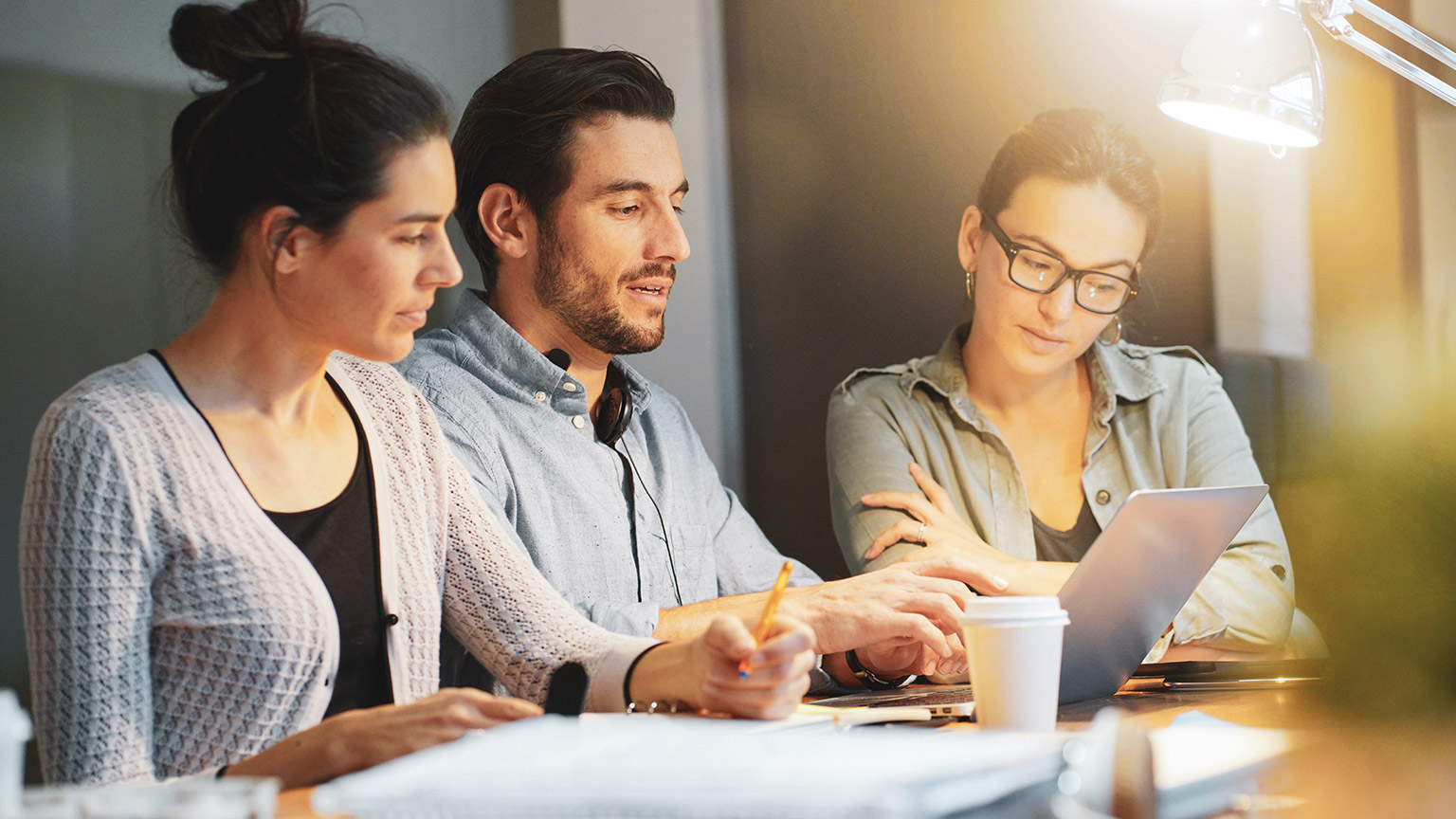 A group of people meeting and discussing business in an office