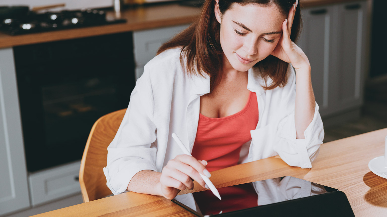 A person working on a tablet in a relaxed environment