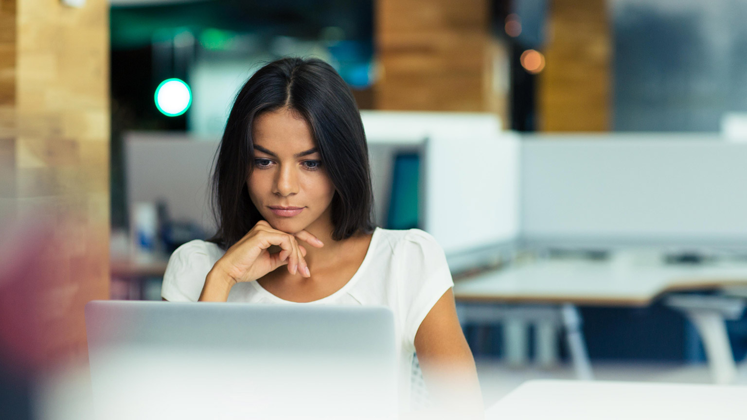 A business person reviewing information on a laptop