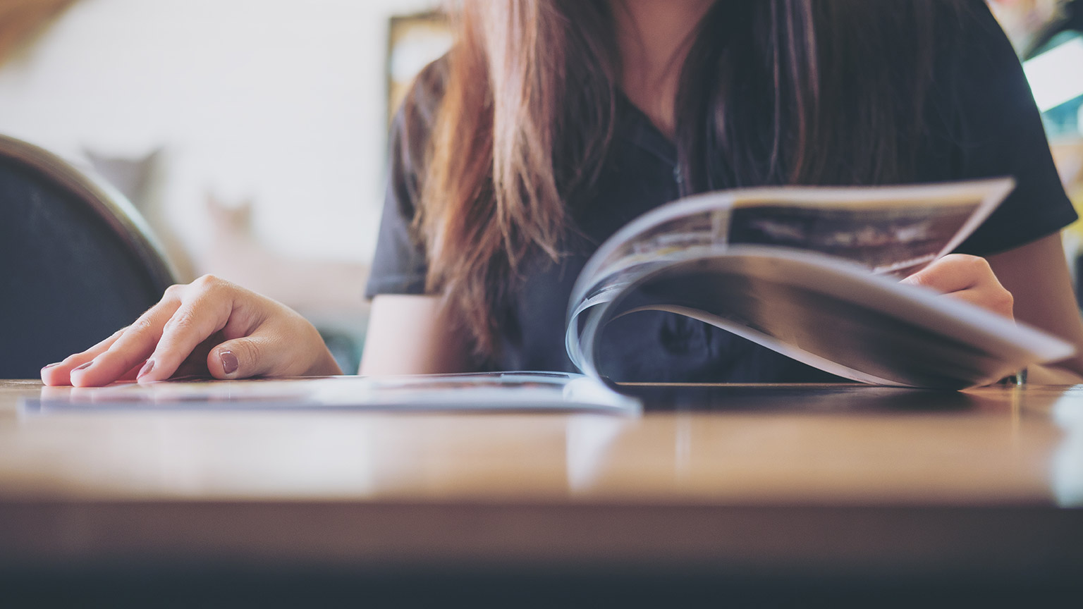 A person reading a magazine