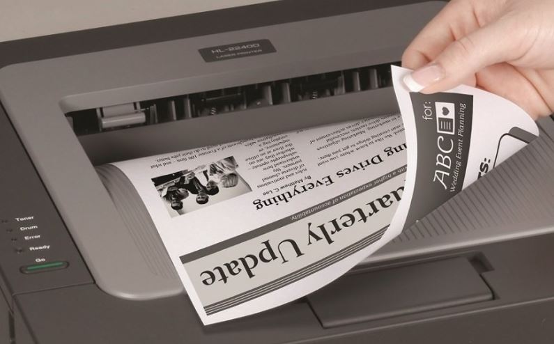 A printer showing a page printed on both sides of the paper