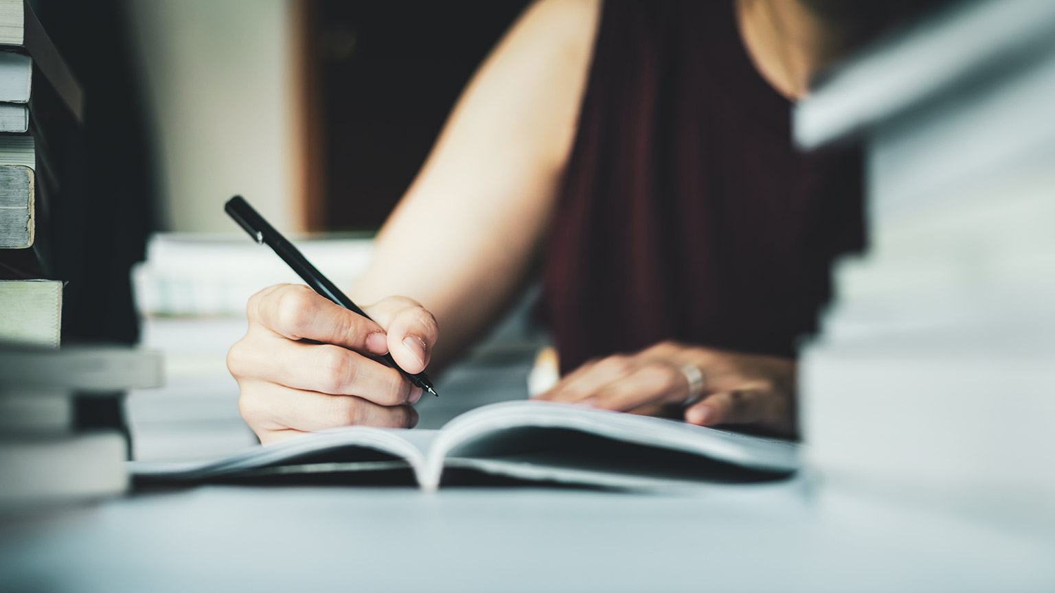 A person writing notes at a desk