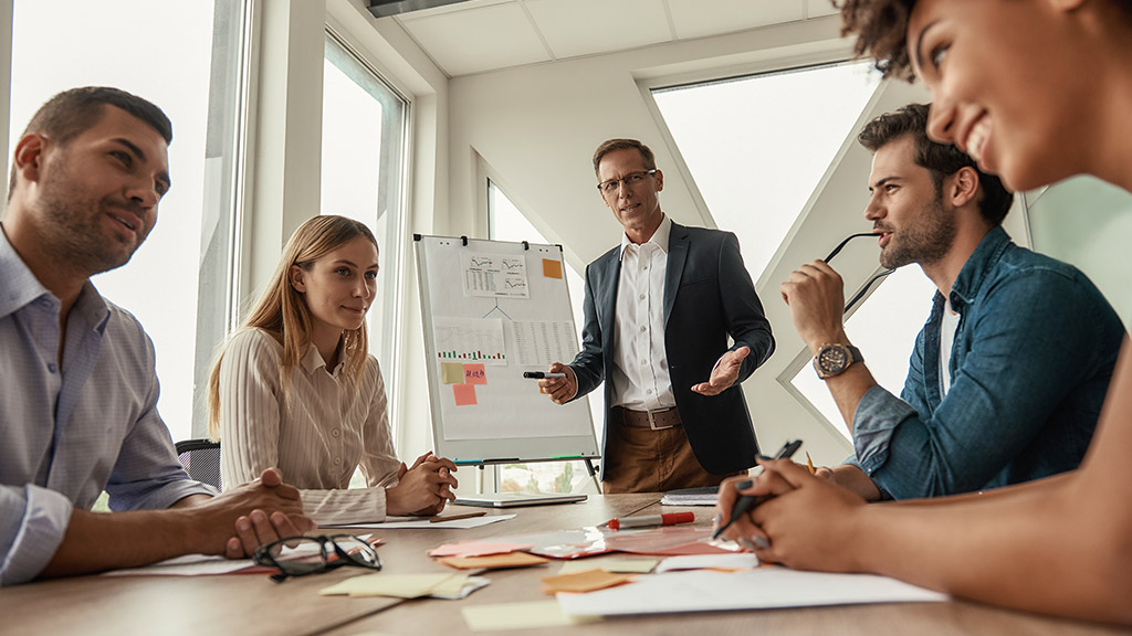 man working with his colleagues and explaining something to his colleagues