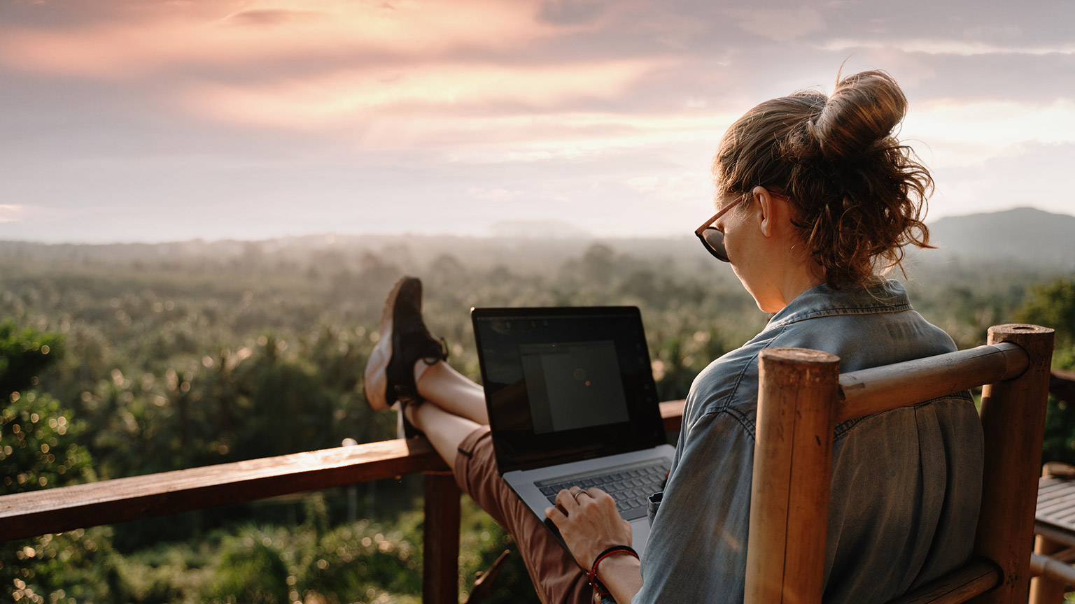 A person using a laptop outdoors