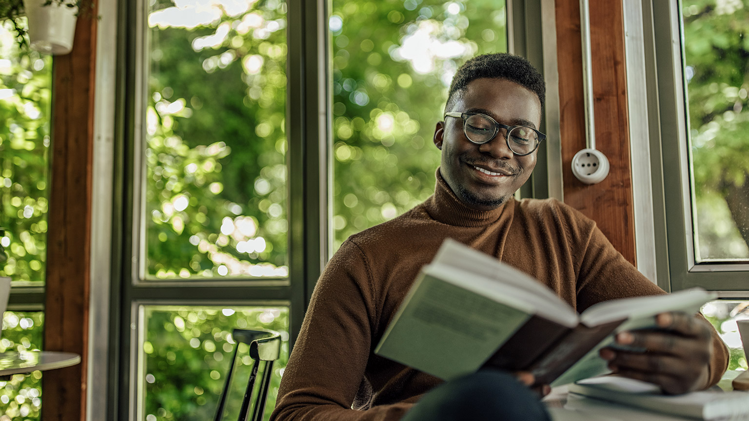 man, spending his work break by reading a book