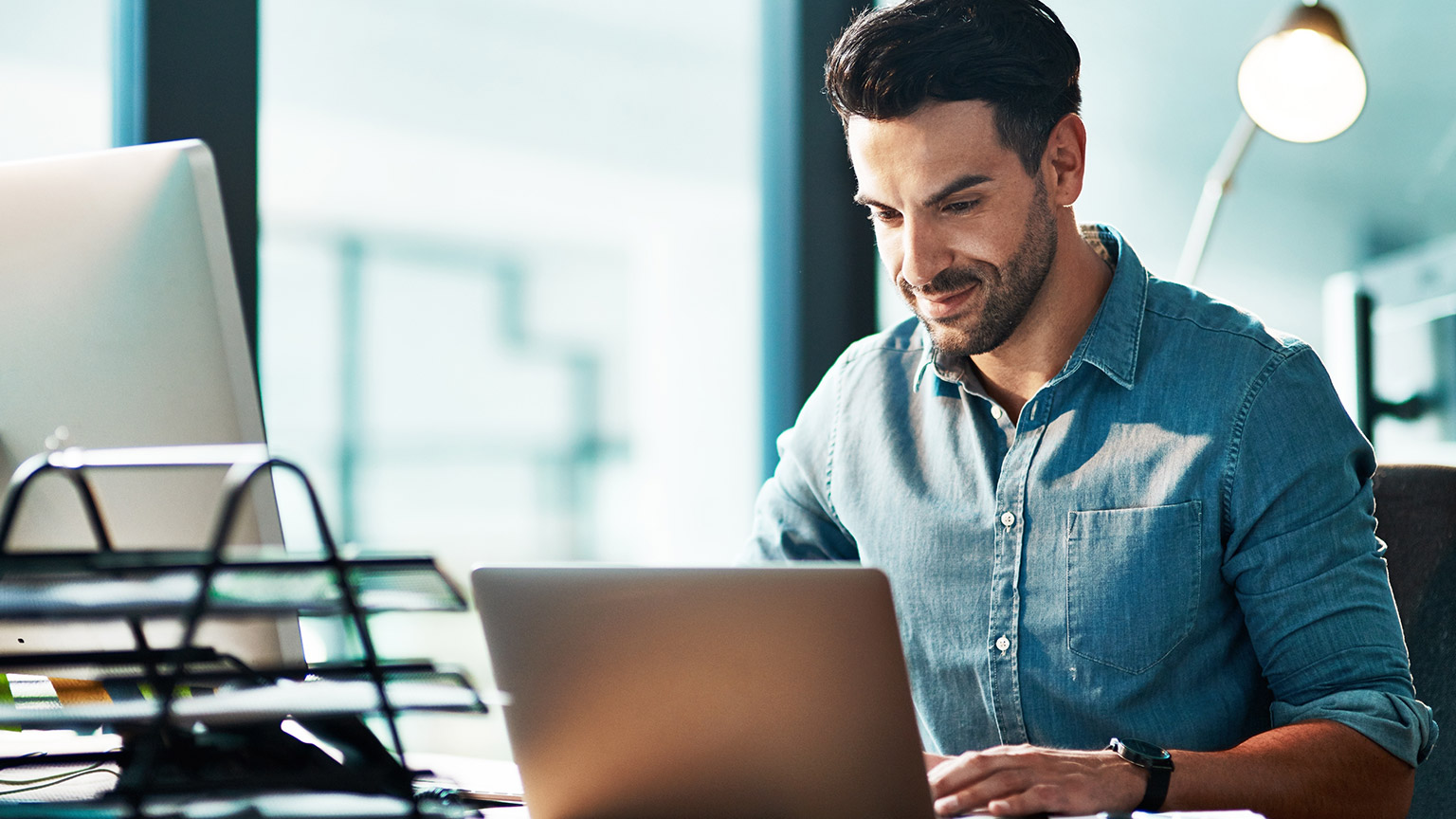 A person working on a laptop in an office