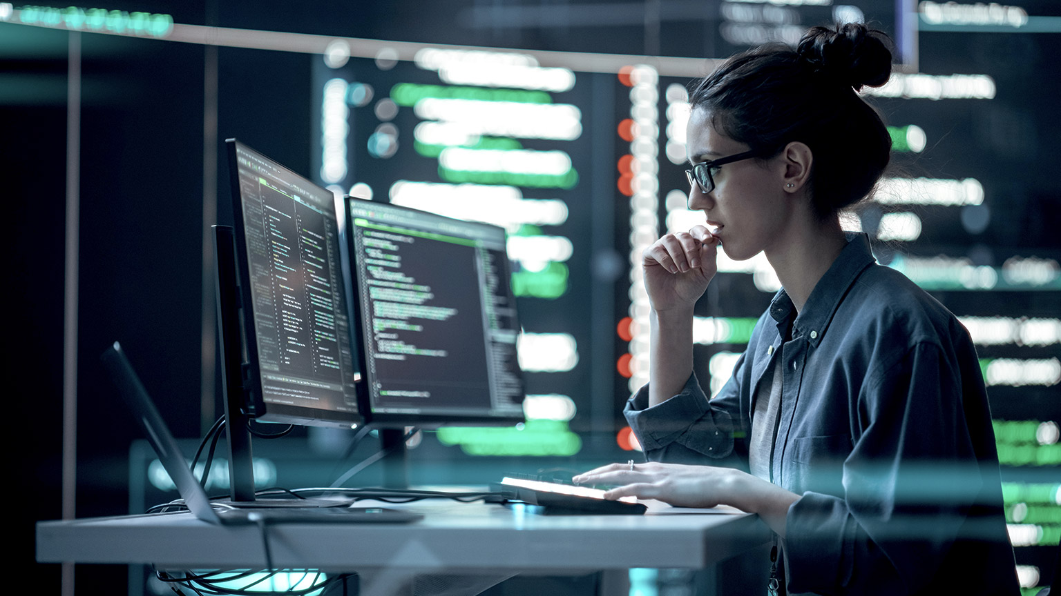 Female programmer thinking and typing infront of the computer