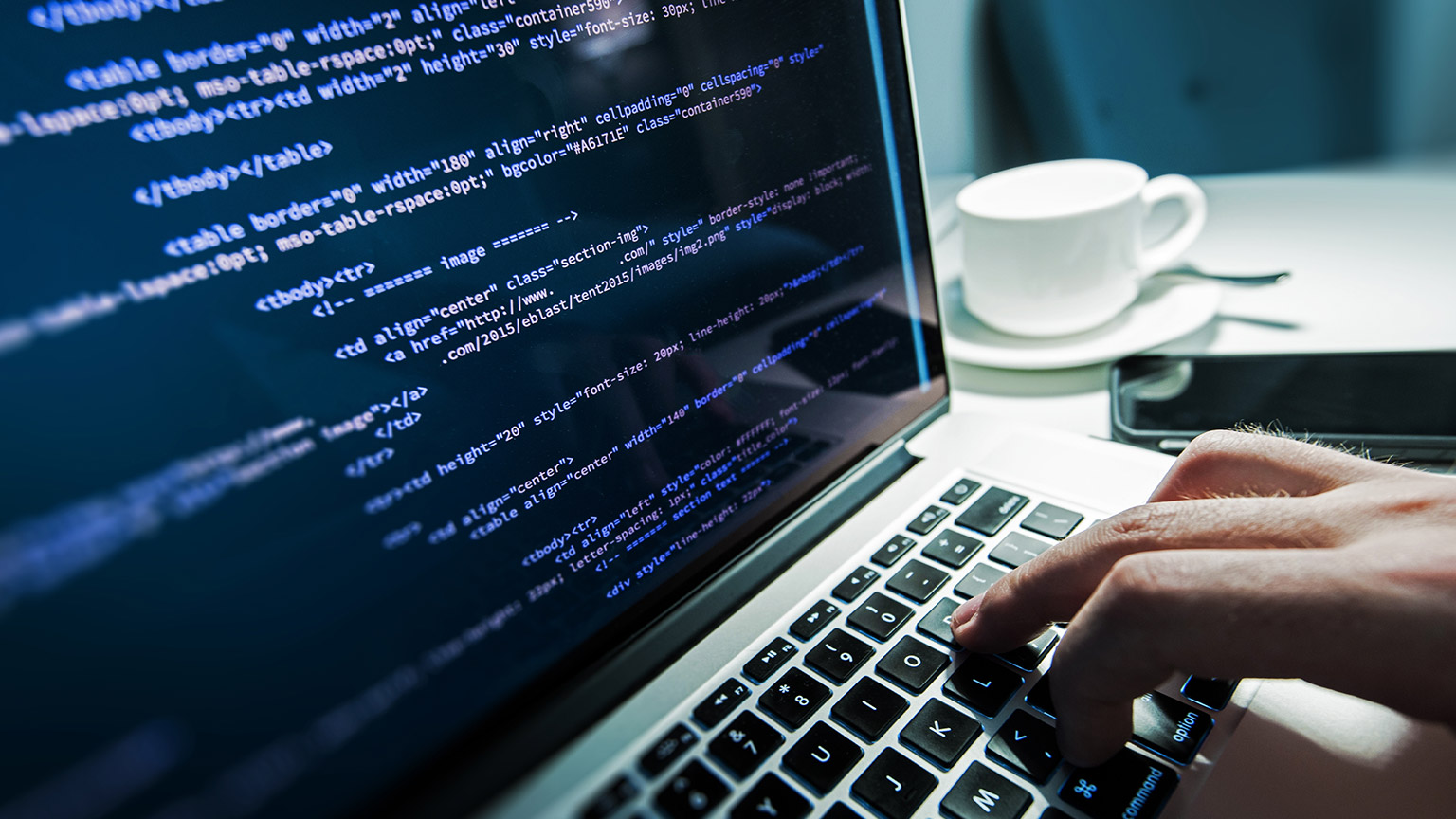 A close view of a person working on a laptop