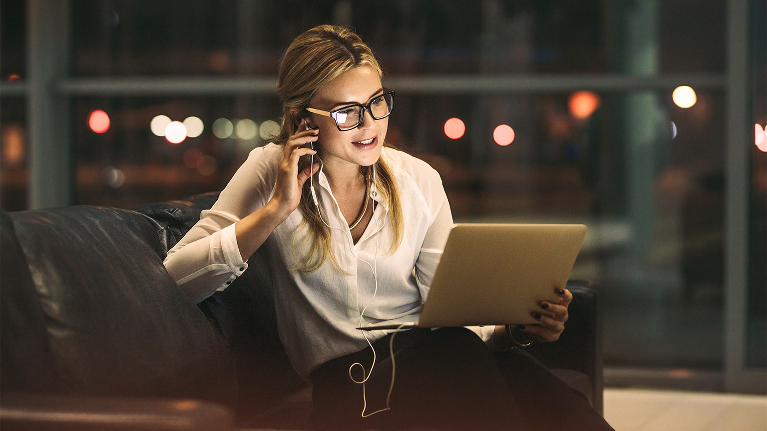 Businesswoman working late in office, doing a video call with digital tablet.