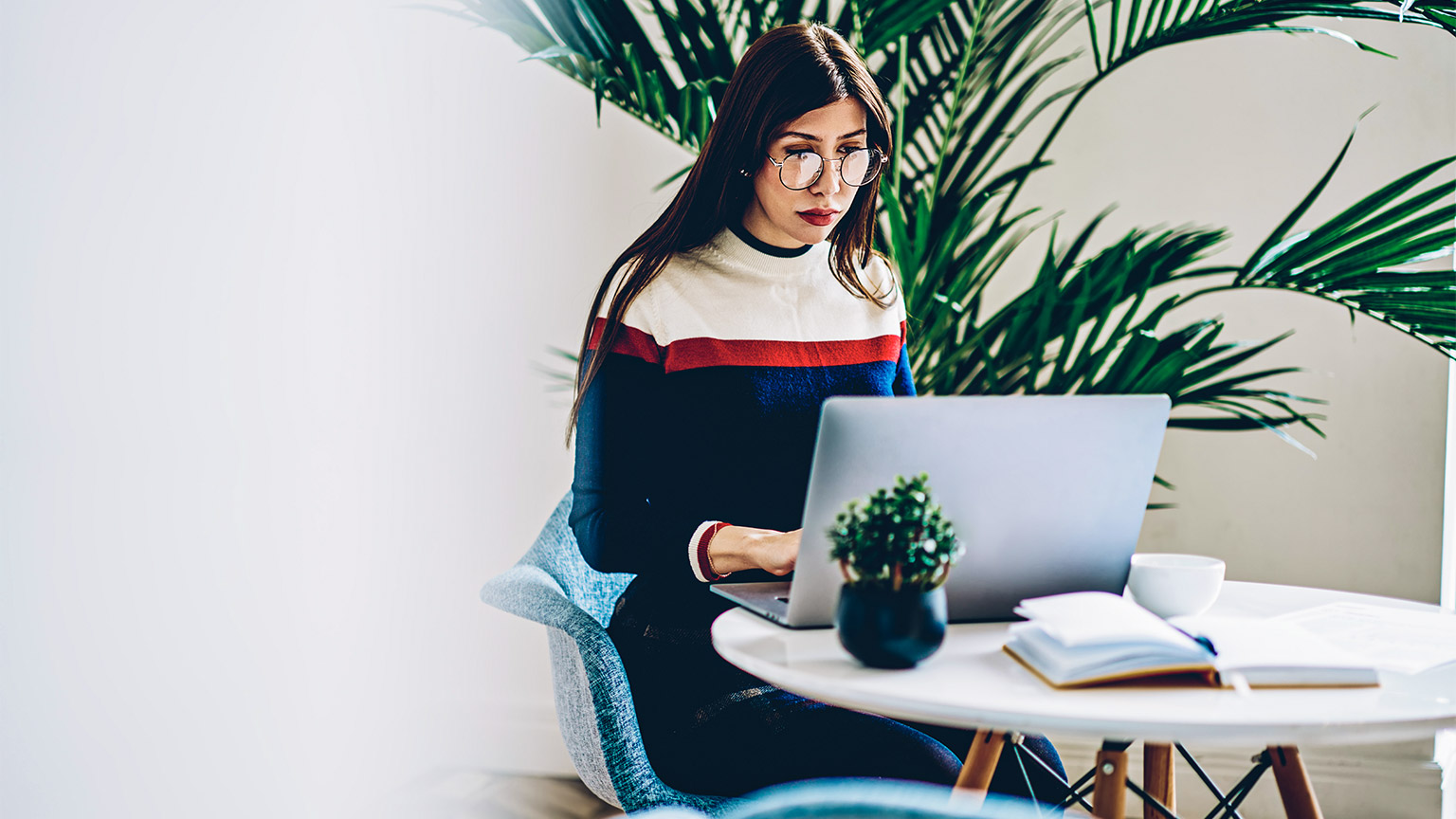 A young professional seated in a common area of their organisation, completing time-sensitive tasks in line with their schedule