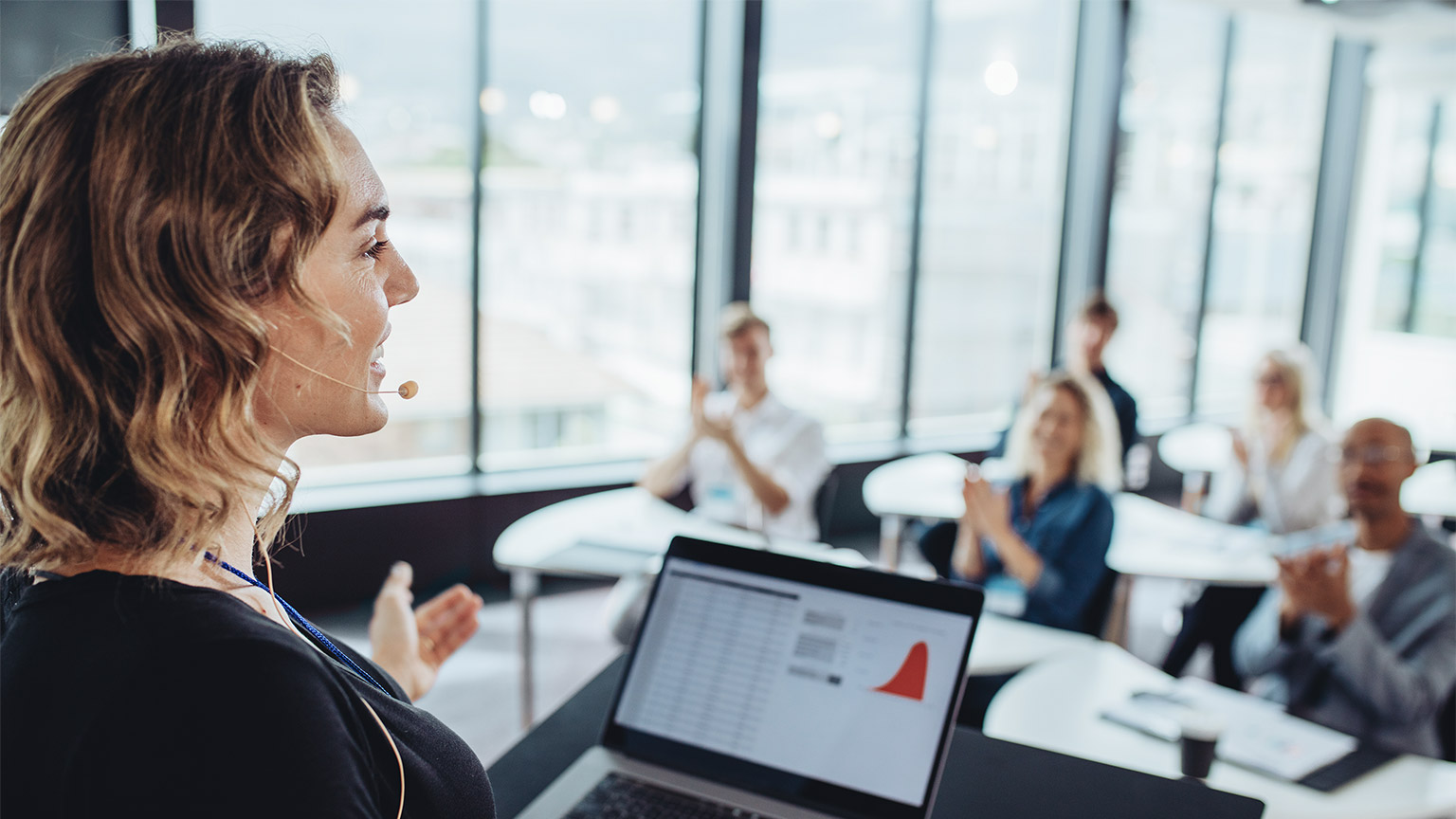 Businesswoman talking to business people from a podium. 