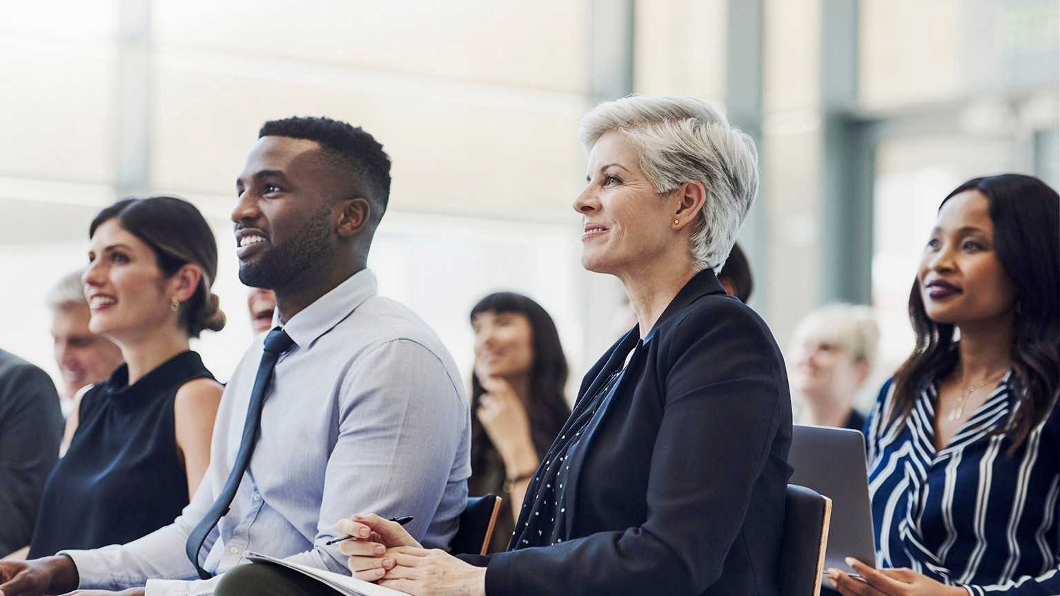 Shot of a group of business people attending a conference