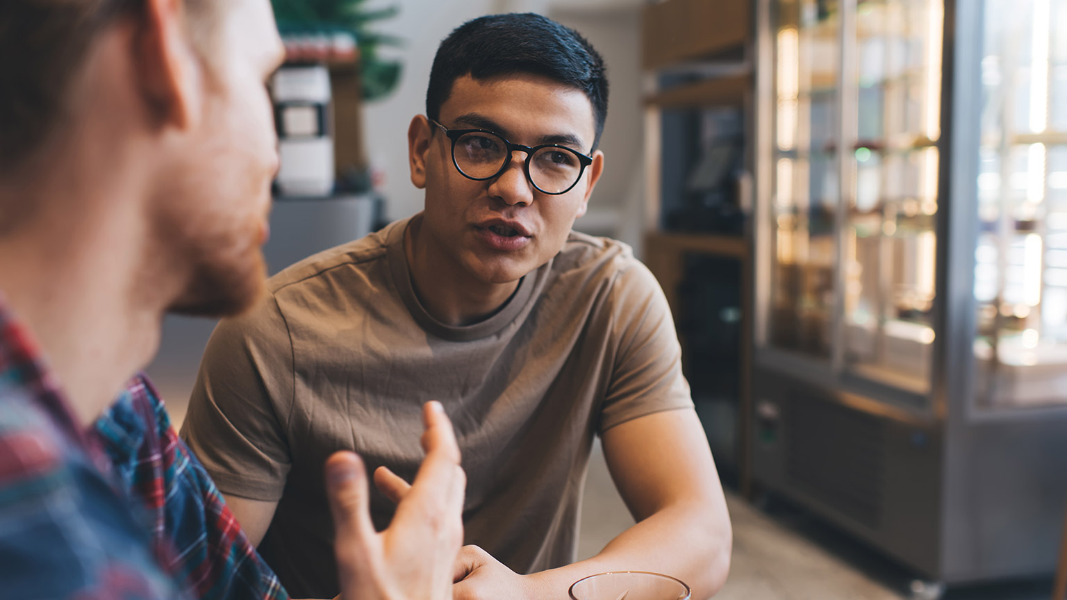 Two coworkers talking in an office setting