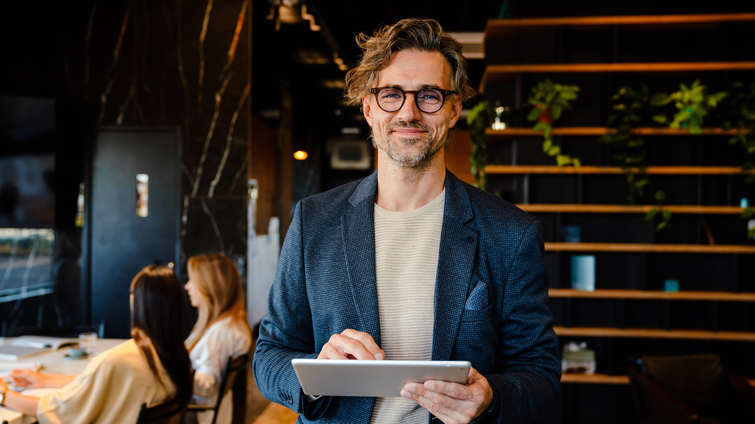 A professional person standing in a modern office location