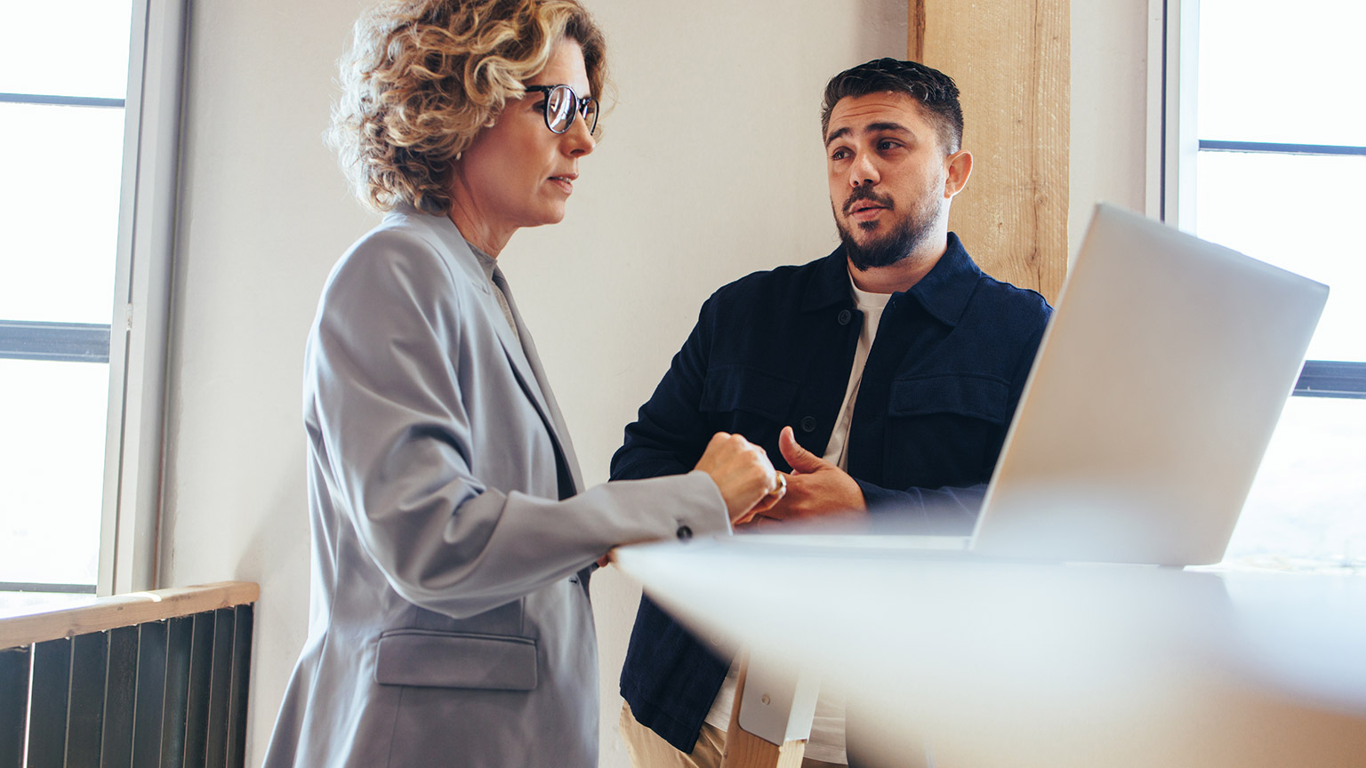 Colleagues talking in an office