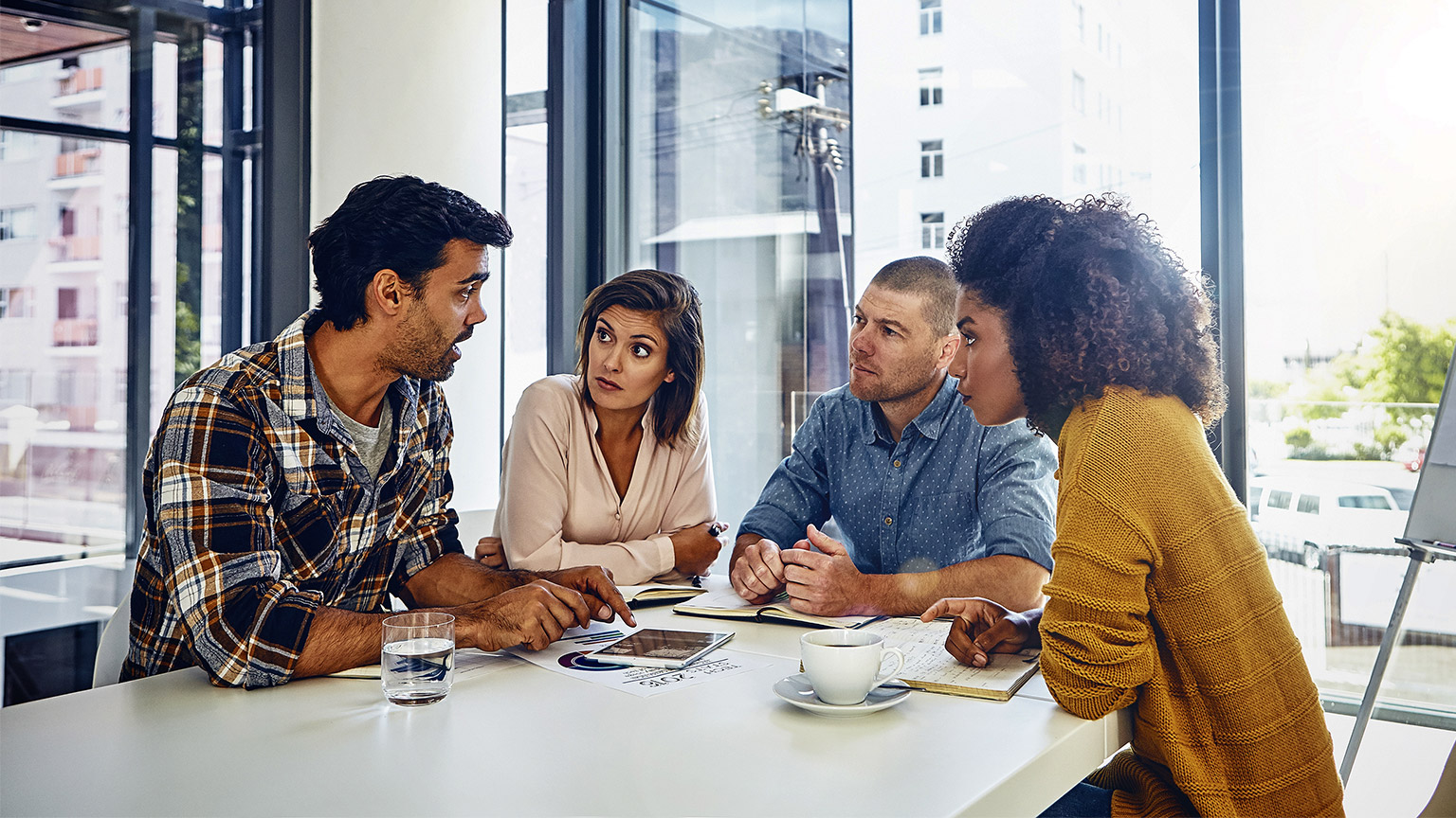 a group of people having a discussion or meeting at the office