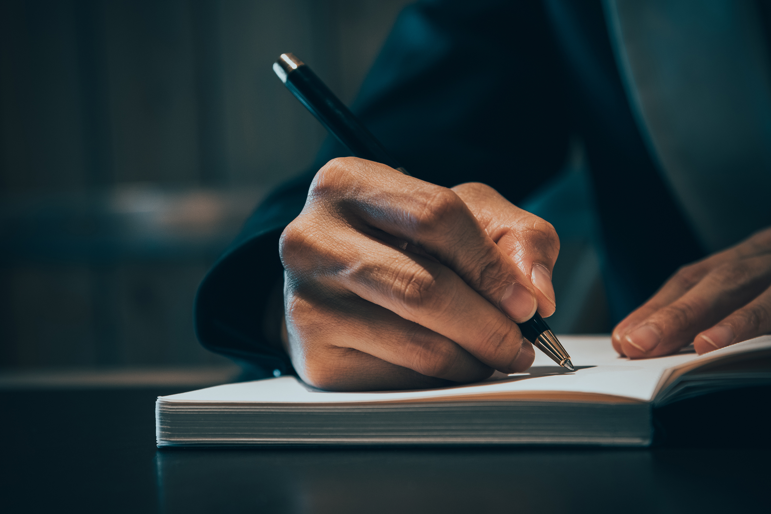 A close view of a counsellor writing notes on paper