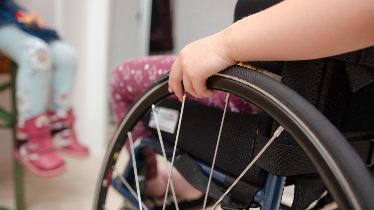 A child in a wheelchair in a play facility