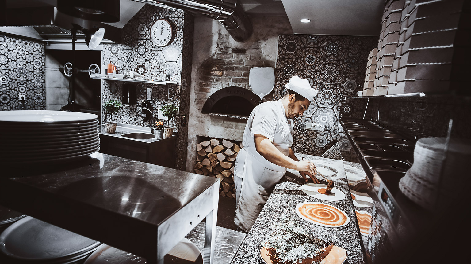 Chef preparing pizza in the kitchen