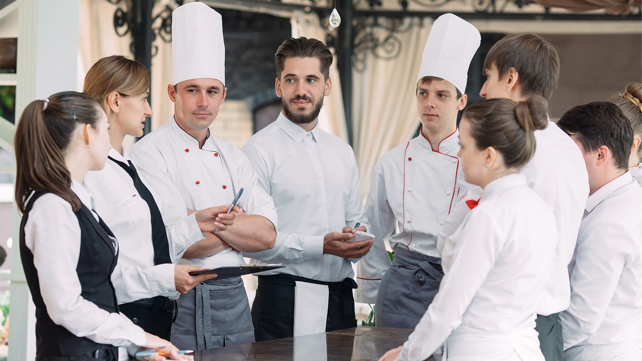 Restaurant manager and his staff in terrace. 