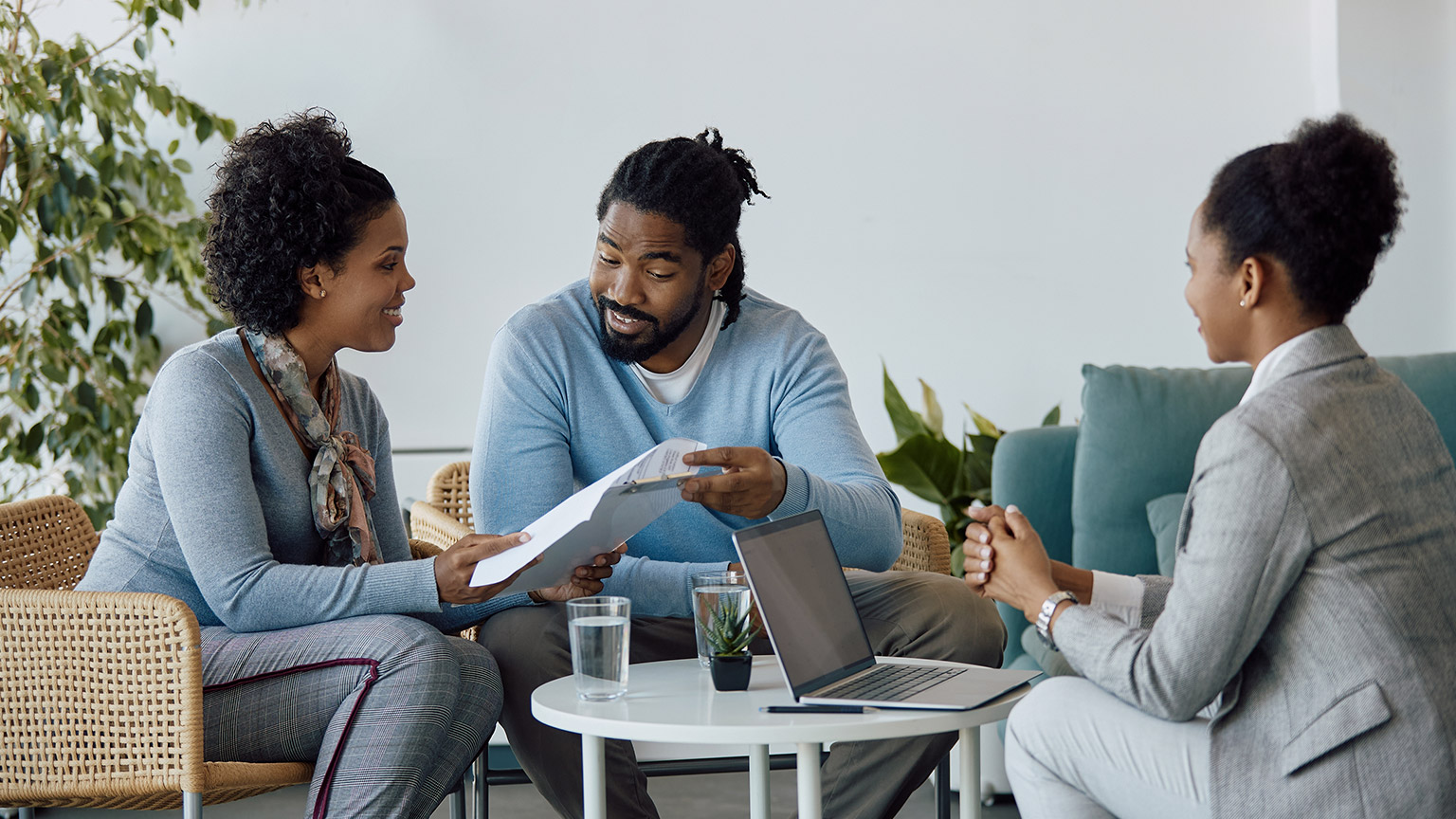 couple going through paperwork with their counsellor on a meeting in the office