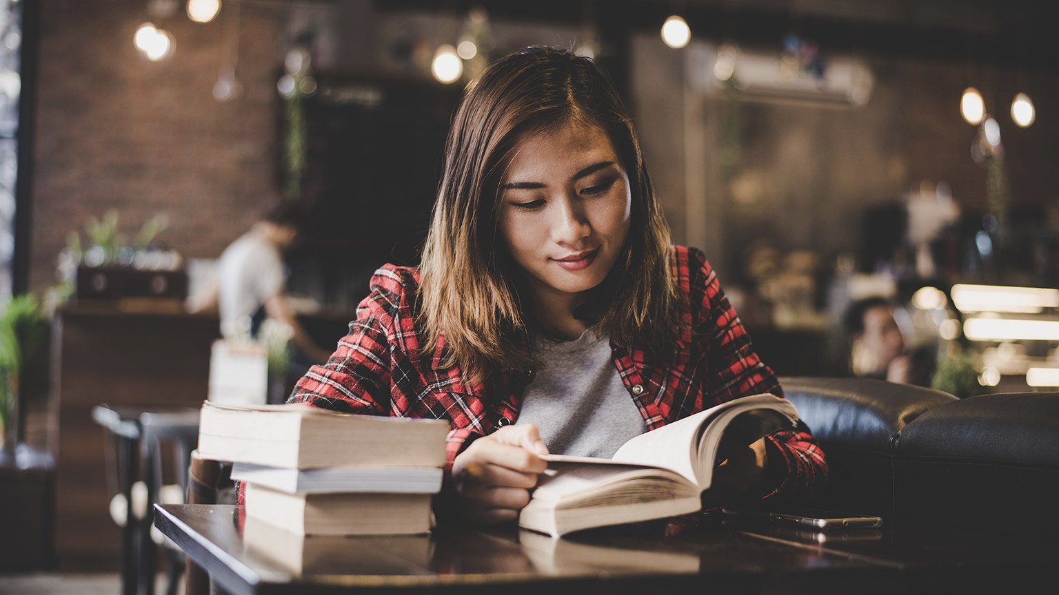  teenager sitting enjoy reading book at cafe