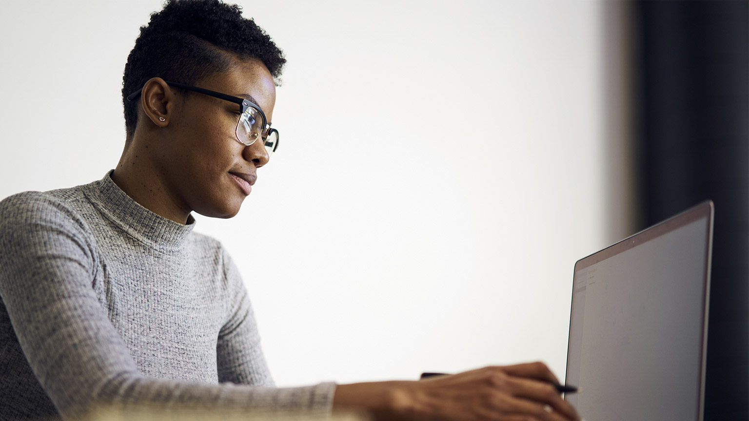 Portrait of intelligent female teacher in glasses reading reports of talented students correcting mistakes and putting marks sending feedbacks on