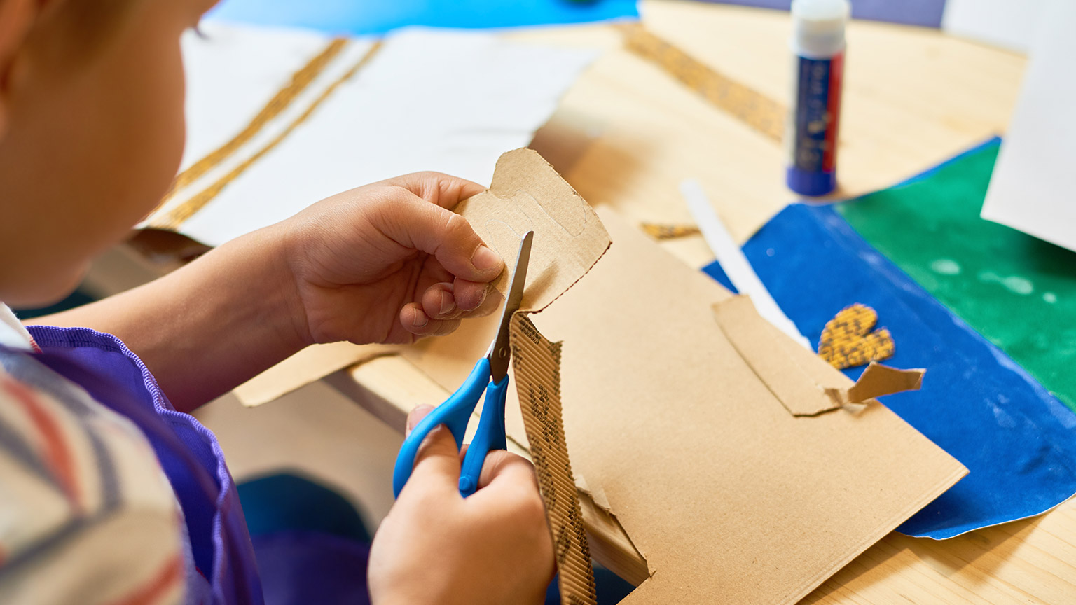 A child using motor skills to cut out with scissors