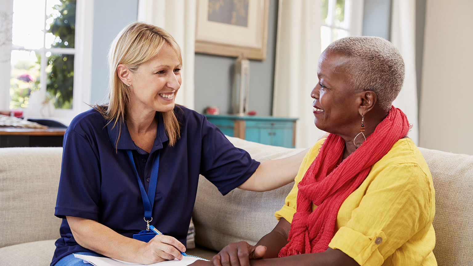 Female Support Worker Visits Senior Woman At Home