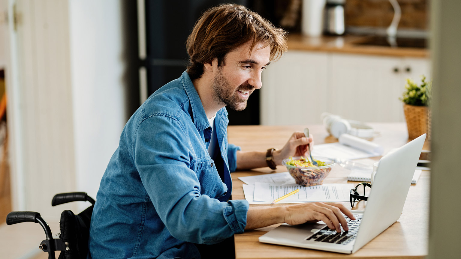 A small business owner reading information on a laptop