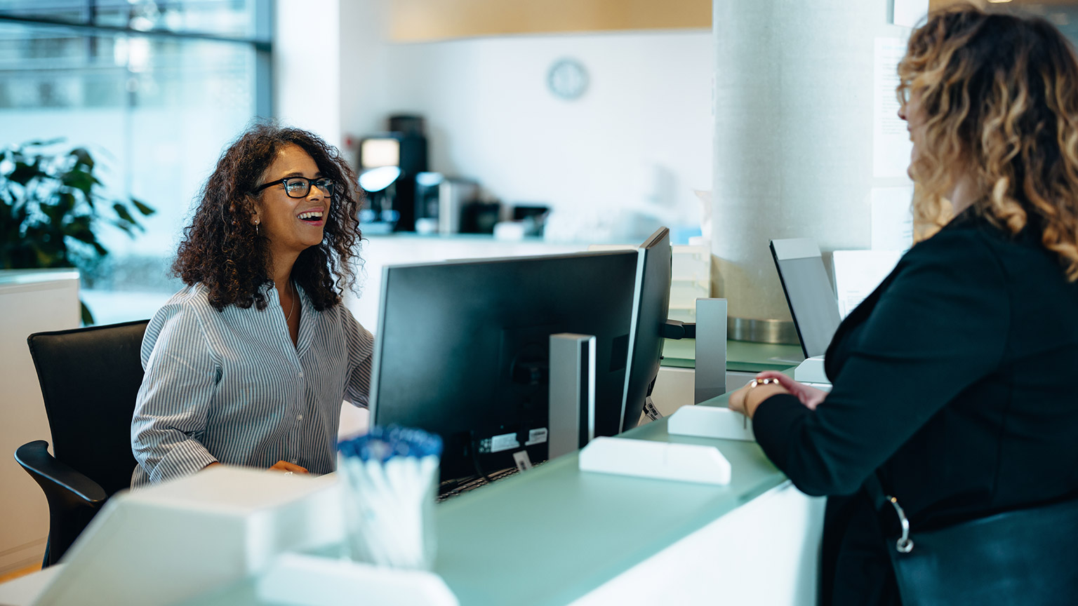 Two people talking in a modern office