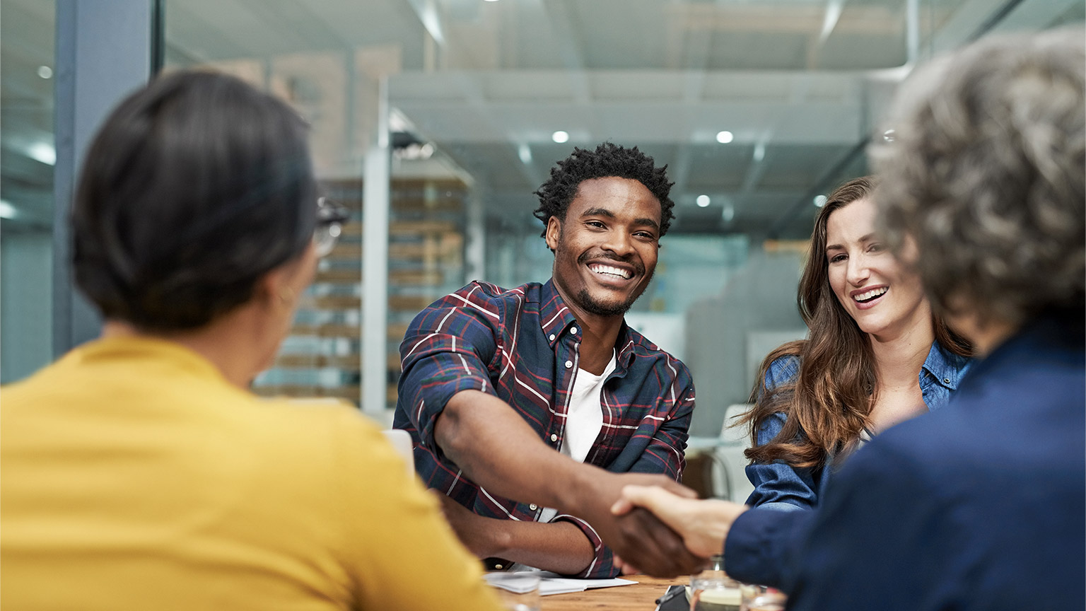 Meeting, man and handshake with team for sales deal