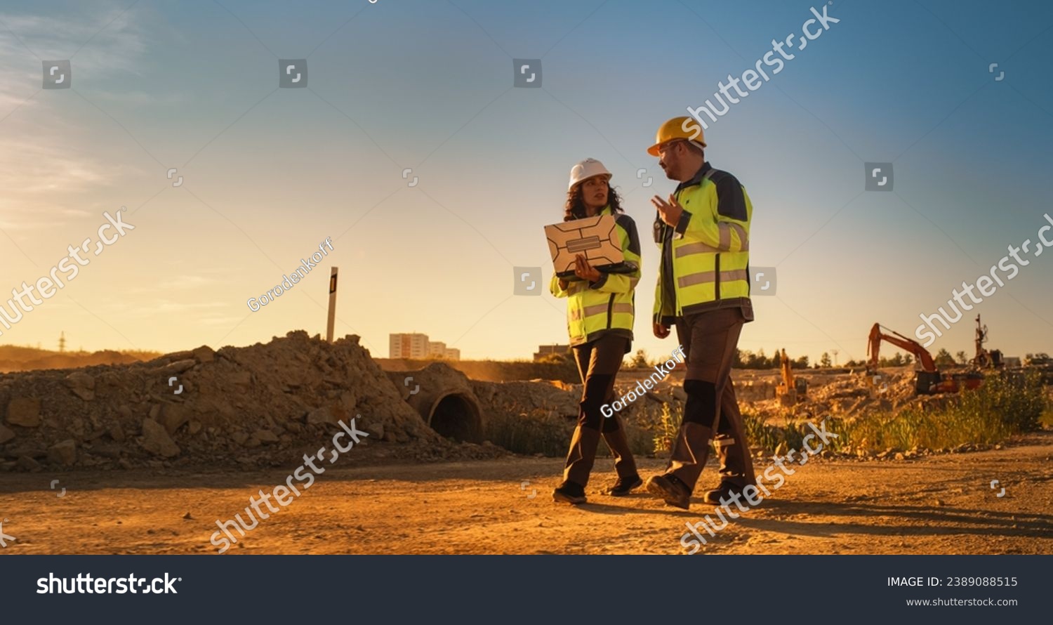 Male and female construction workers on site.