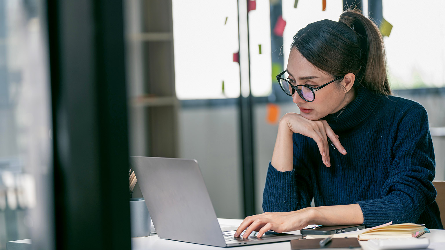 woman working on laptop in her workstation