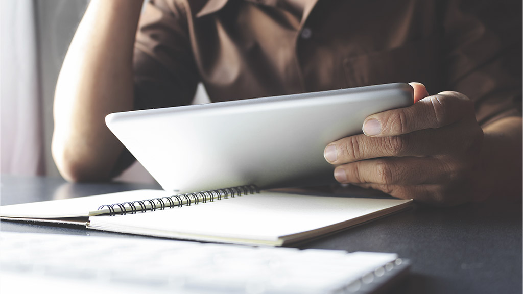 businessman working tablet in office with film colors tone, soft-focus and over light in the background