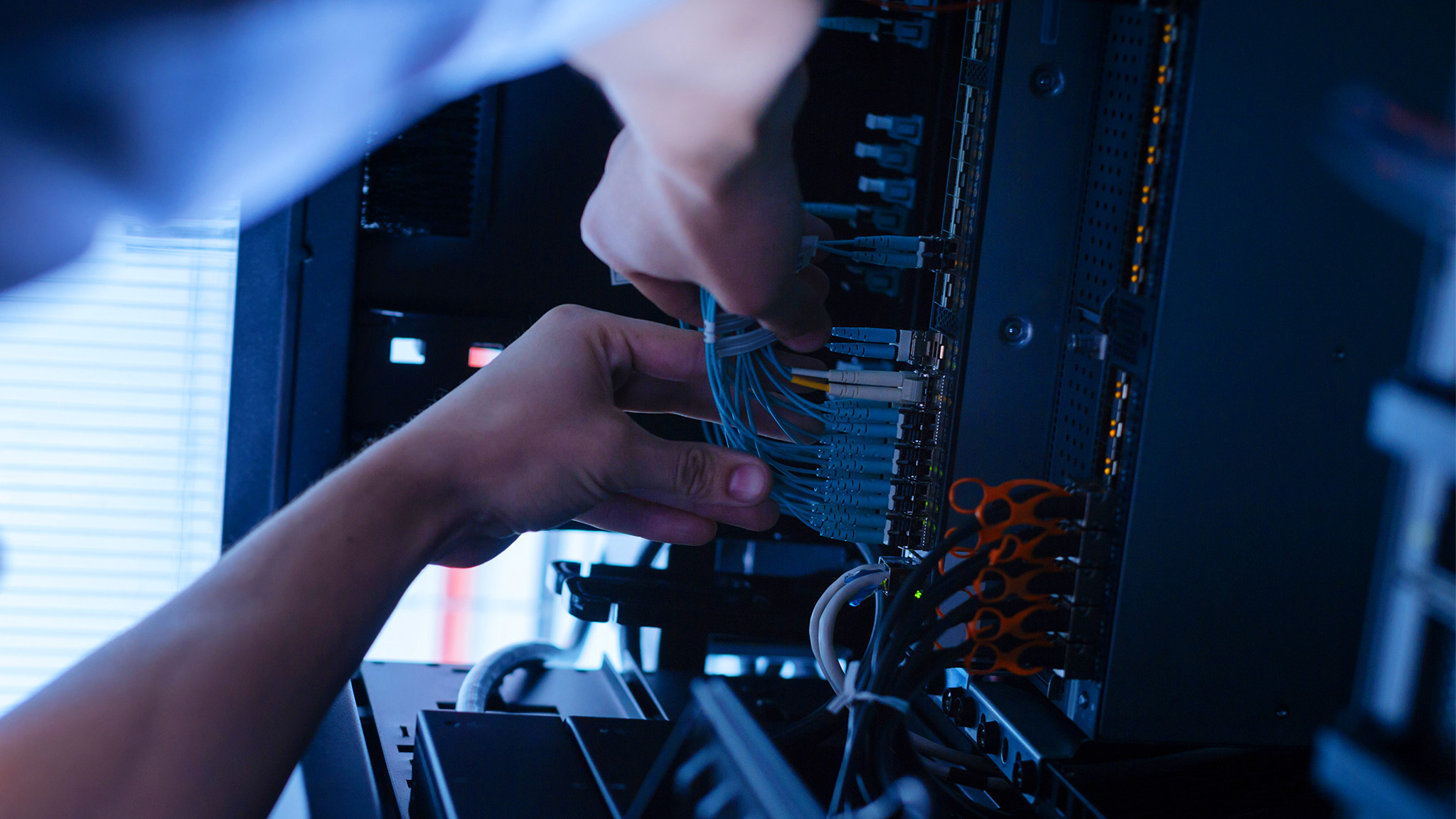 Hard working experienced technician working with network cables.