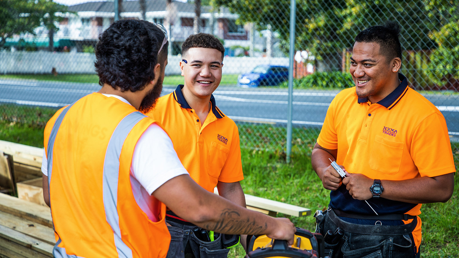 A group of tradies talking on a job site