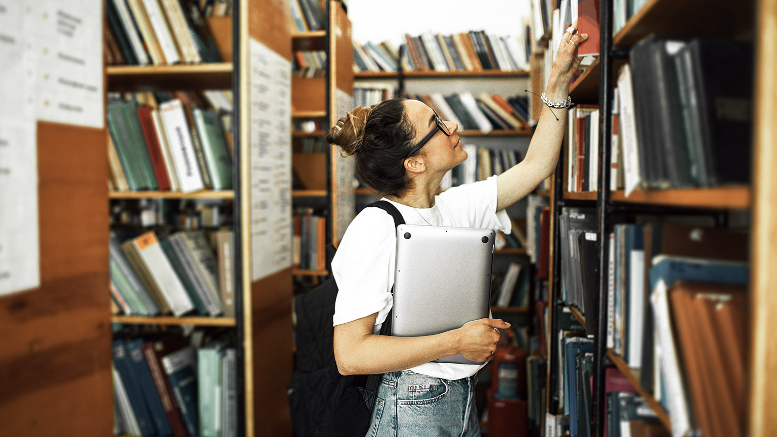 Student taking book from the libary