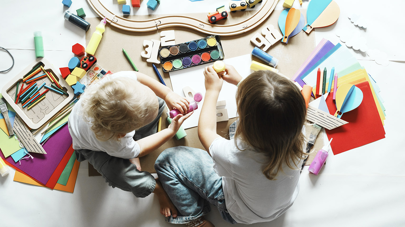 Top view of two kids playing toys