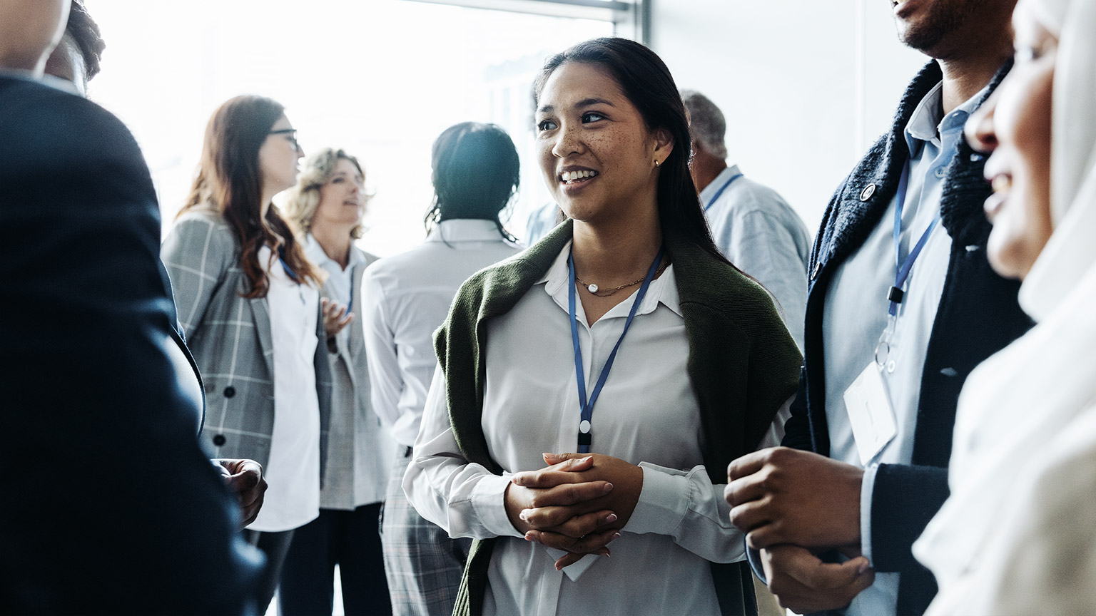 smiling, conversing, and engaging in discussions during a daytime seminar