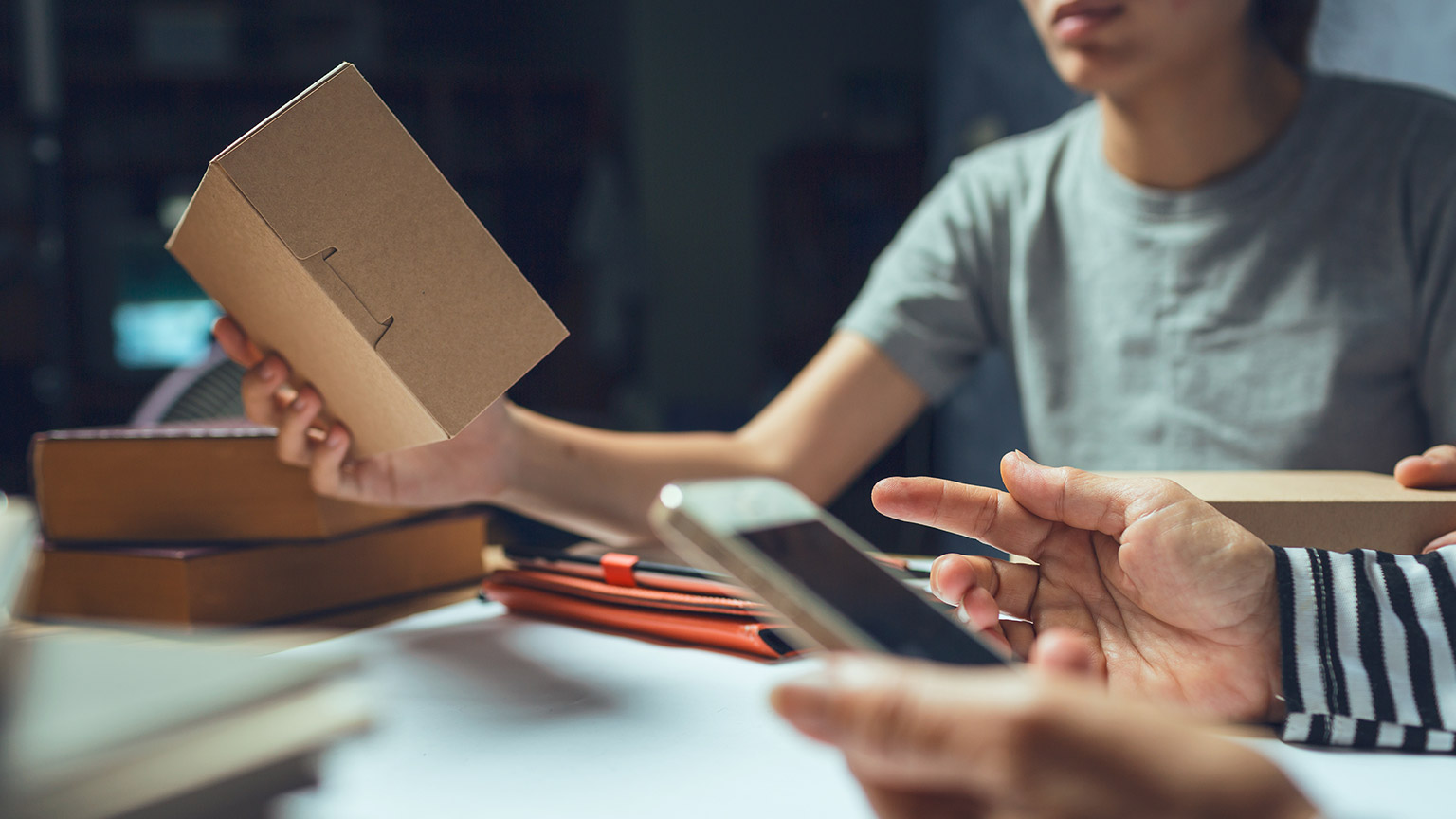 A person looking at a parcel in a small business warehouse