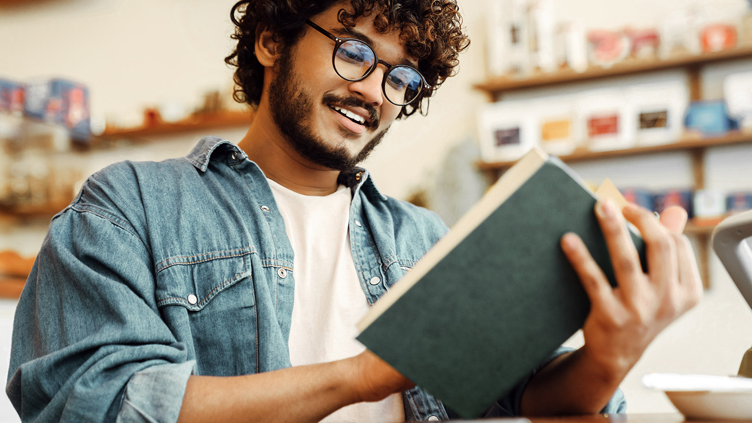 Young man reading books