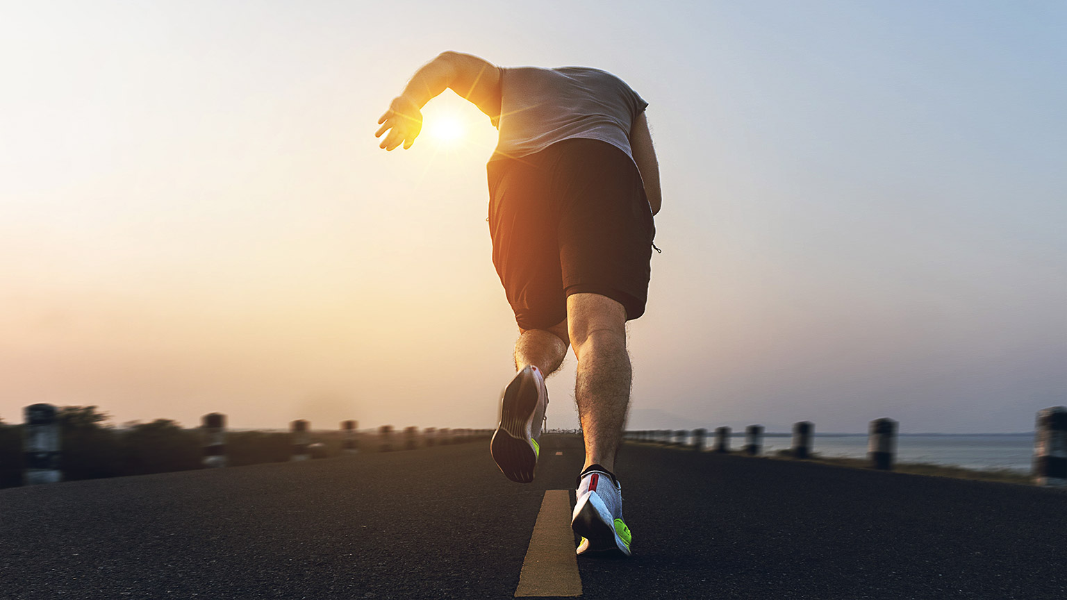 The man with runner on the street be running for exercise