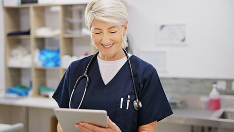 Happy, mature and woman with tablet in vet for veterinary research,