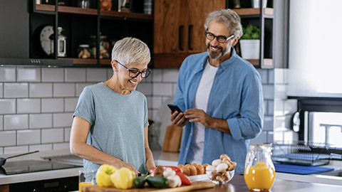 a woman preparing for a food while talking to her husband