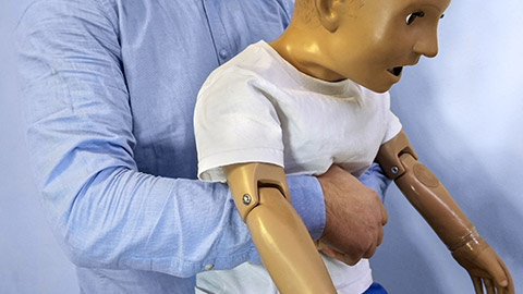 Abdominal thrusts (the Heimlich maneuver or Heimlich manoeuvre) on a simulation mannequin child dummy