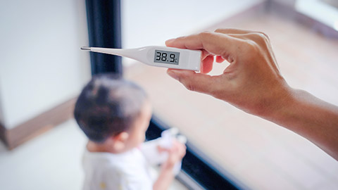 a man holding a thermometer