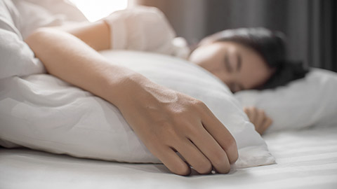 girl on a soft white bed sleeping and relaxing.