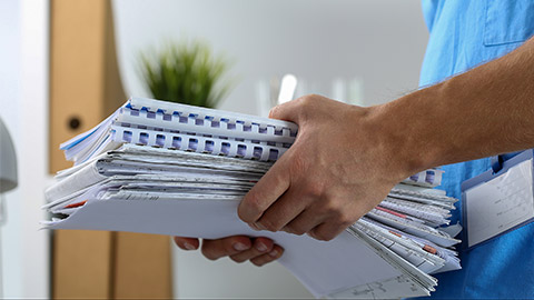 A medical staff holding a bunch of documents